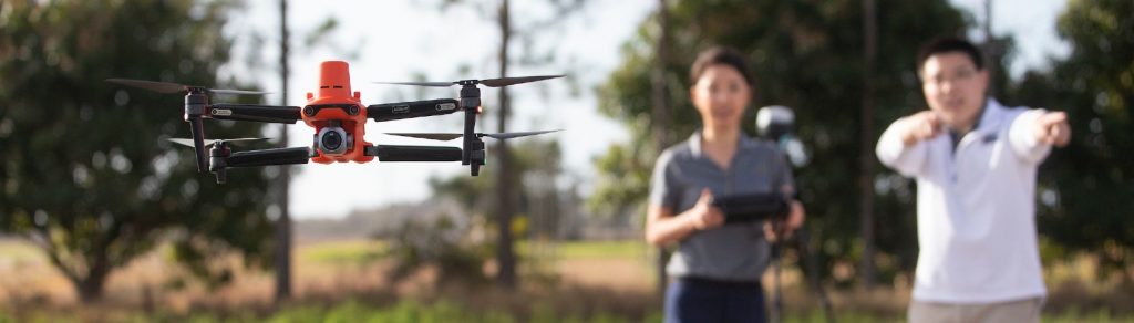 Two scientists flying a drone