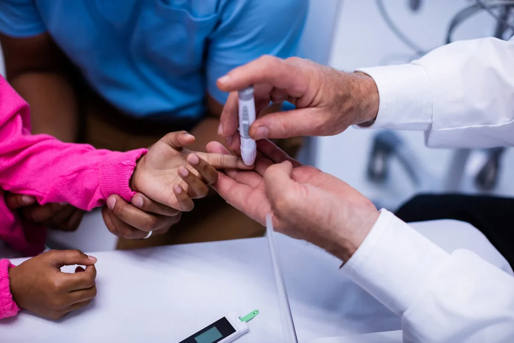 Doctor pricking a child's finger