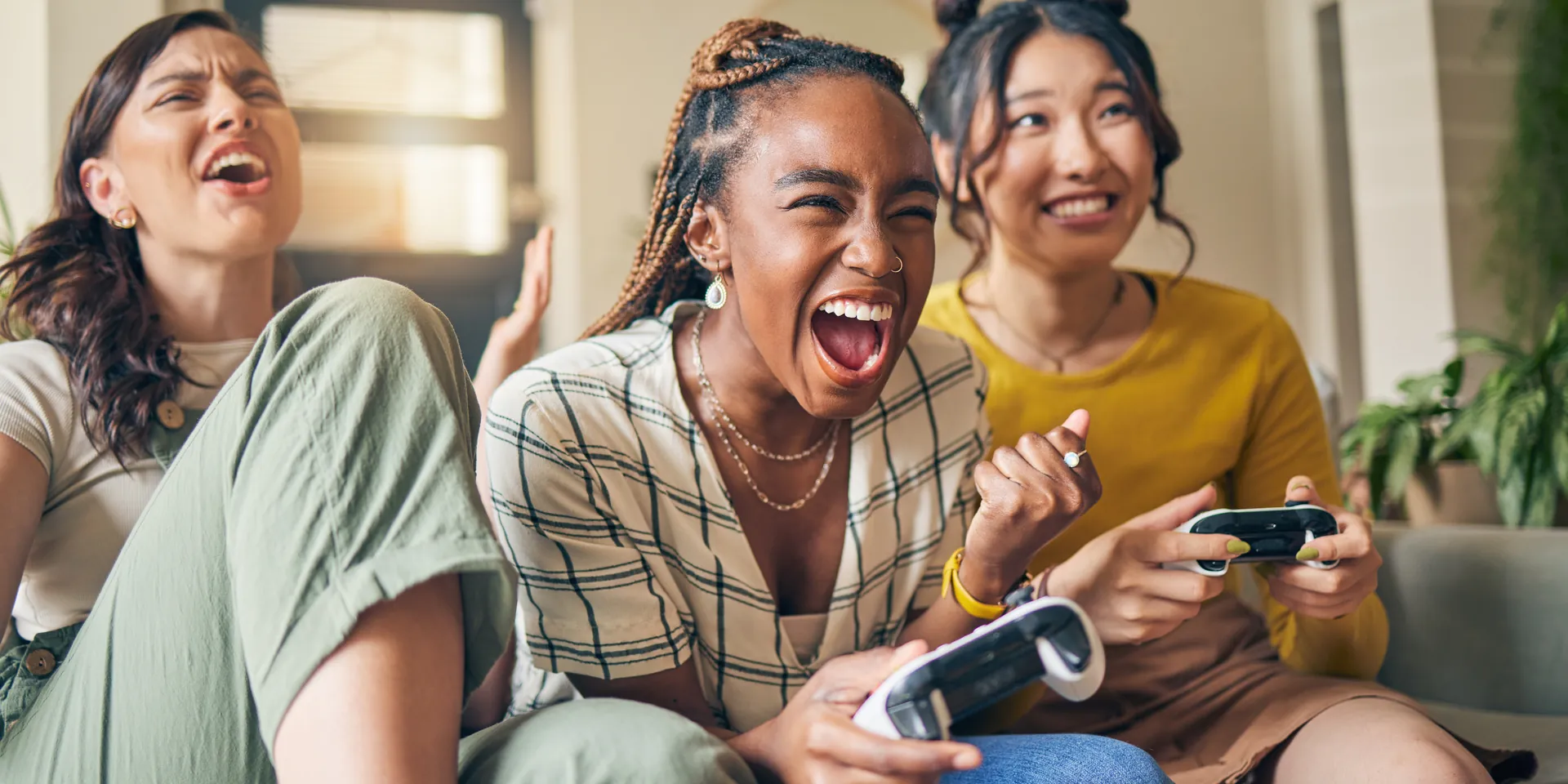 Friends sitting on a couch laughing together